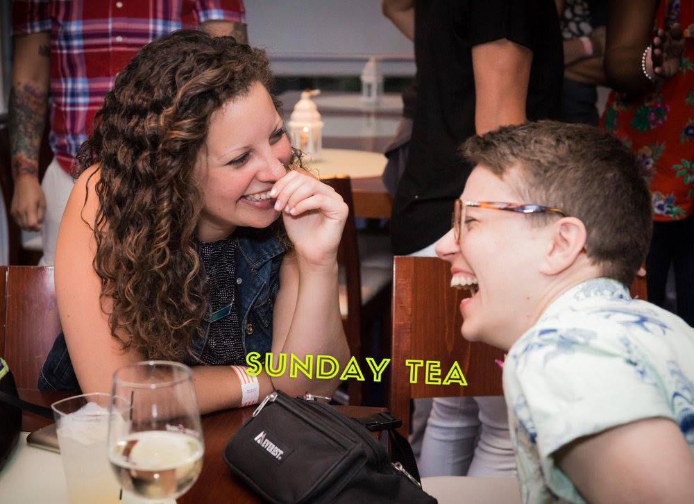 two women looking at each other and laughing